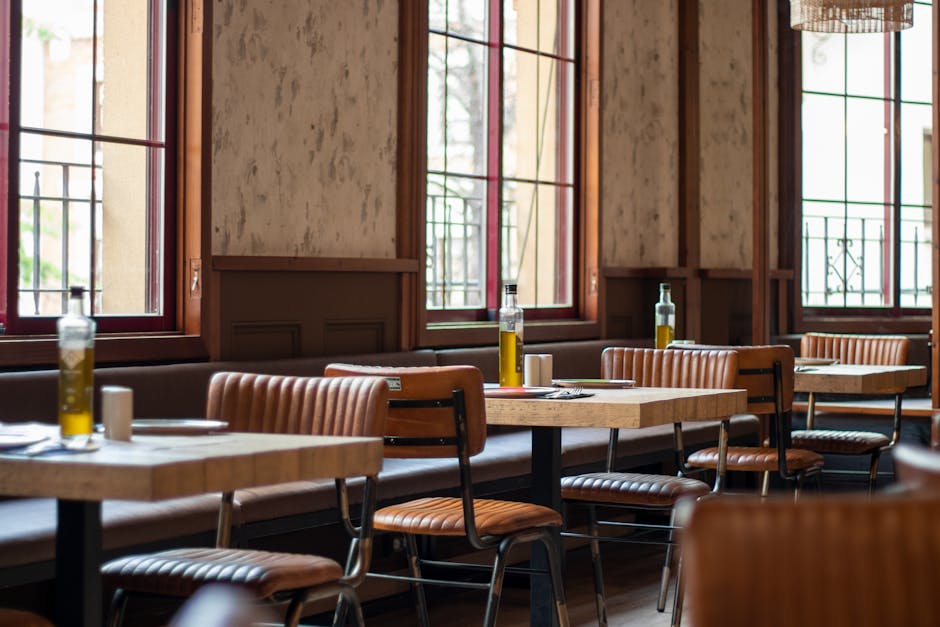 Charming Jaén restaurant featuring olive oil bottles on tables and elegant decor.